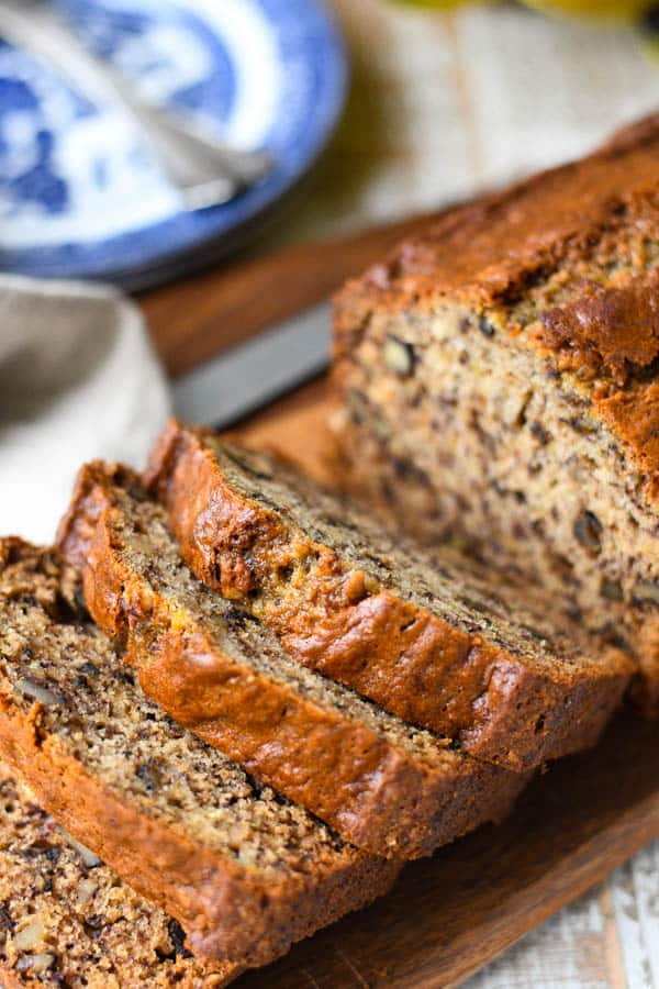 Loaf of the best banana nut bread sliced on a cutting board