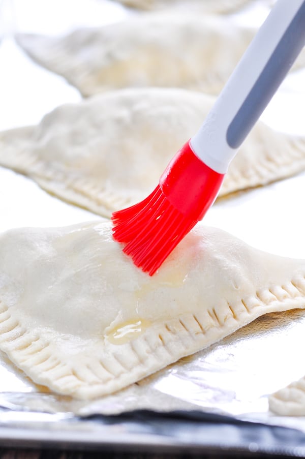 Brushing turkey pot pie crust with butter
