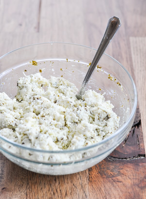 Ricotta cheese mixture in glass bowl for Crock Pot lasagna