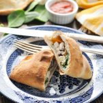 Chicken and Spinach Calzone recipe cut in half on a plate