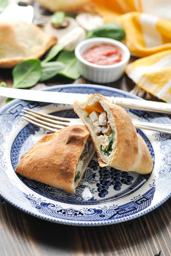 Chicken and Spinach Calzone recipe cut in half on a plate