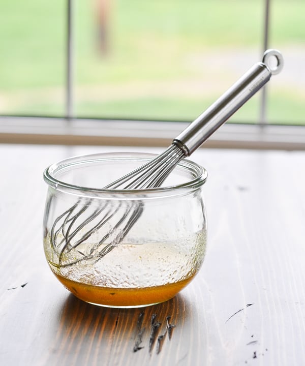 Ramen Noodle Salad dressing in a glass bowl with whisk
