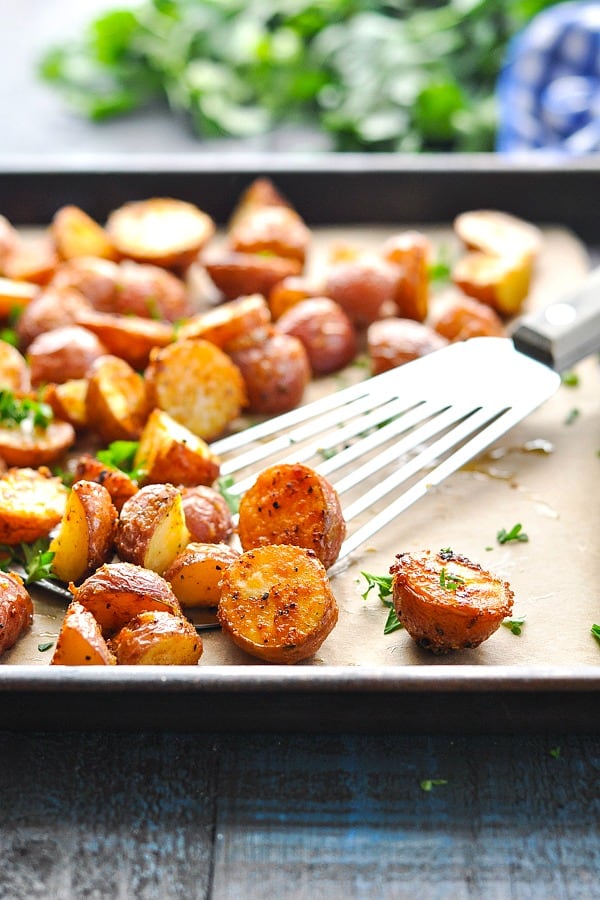 Herb roasted potatoes with crispy exterior on a baking sheet