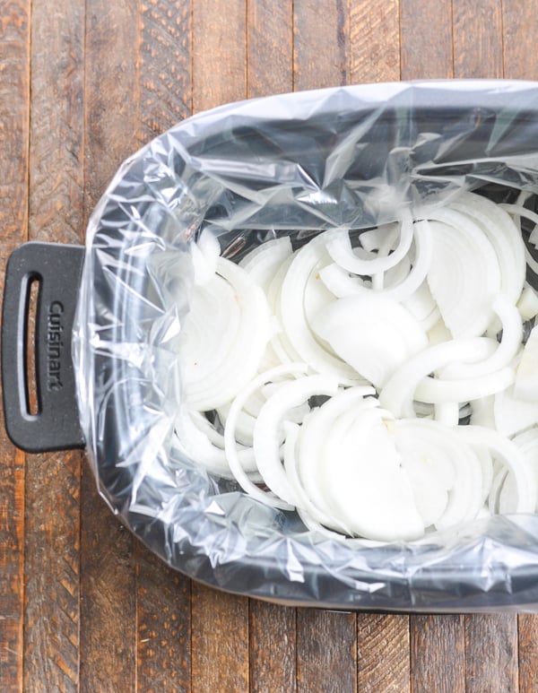 Sliced onions in bottom of slow cooker