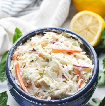 Close up shot of homemade coleslaw in a blue bowl
