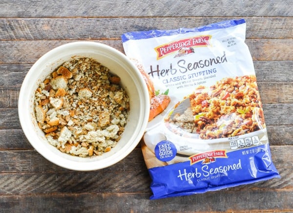 A bowl of Pepperidge Farms Herb Seasoned stuffing, next to the bag on a wooden countertop.
