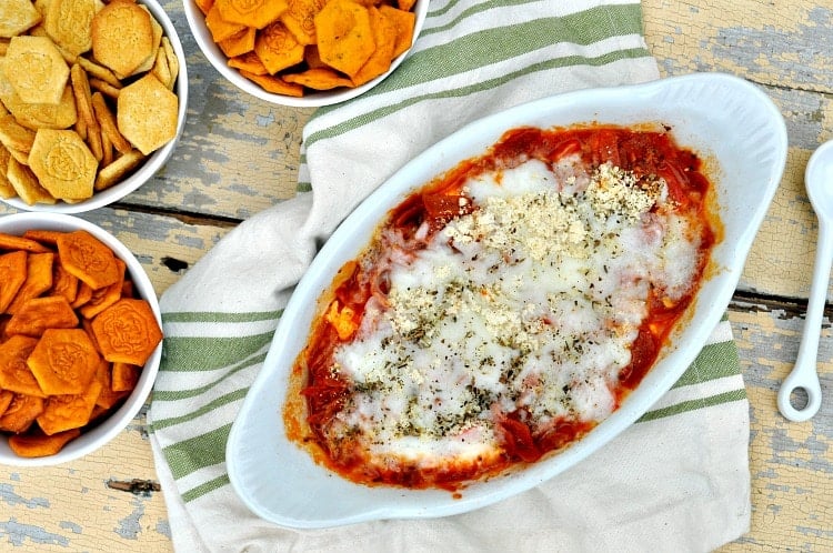 Microwave Pizza Dip in a white dish with crackers beside it