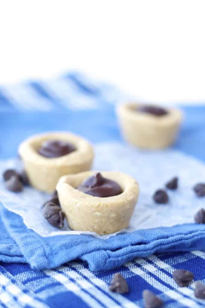Mini no-bake peanut butter cookie cups, each filled with a small dollop of chocolate filling.