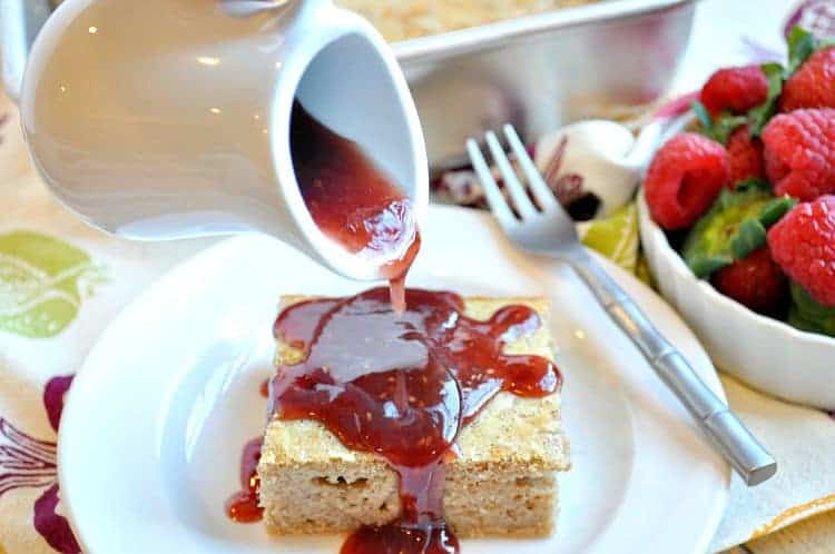 Peanut Butter and Jelly Baked Pancakes on a plate with a syrup drizzled over