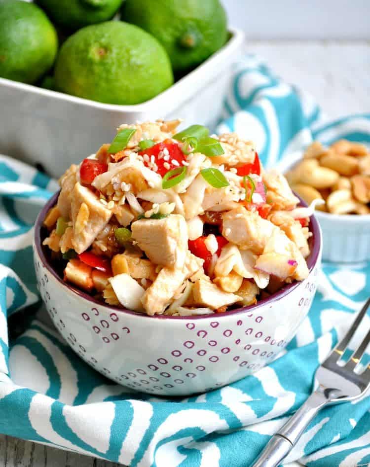 A bowl of thai peanut chicken salad in a colorful bowl