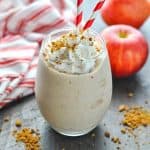 Healthy apple pie smoothie in a glass with text overlay