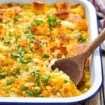Serving spoon in a baked leftover cornbread casserole with chicken.