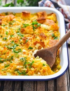 Serving spoon in a baked leftover cornbread casserole with chicken.