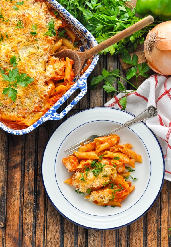Overhead image of bowl of Healthy Chicken Parmesan Casserole garnished with fresh herbs