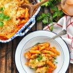 Healthy Chicken Parmesan Casserole in a bowl and baking dish with text overlay
