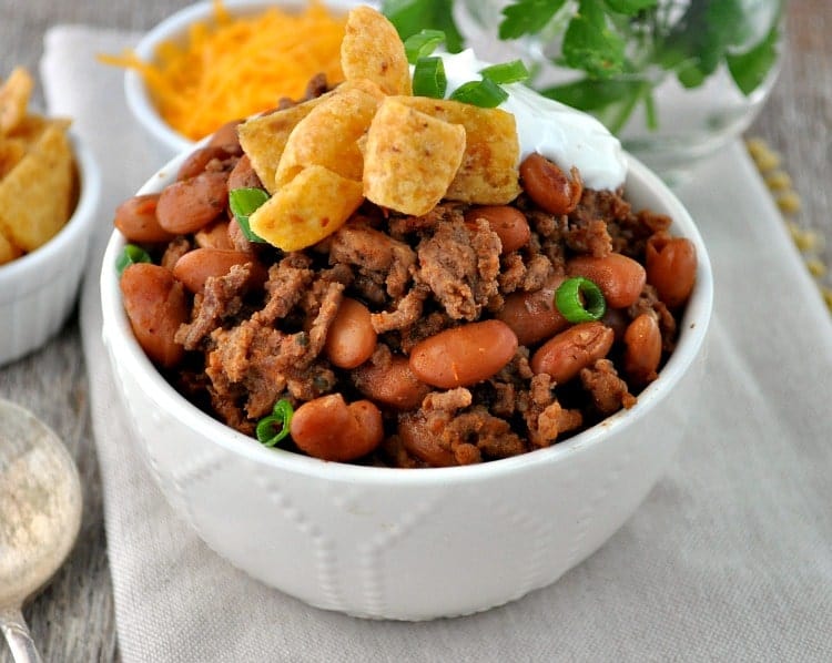 Cowboy Chili  in a white bowl topped with chips