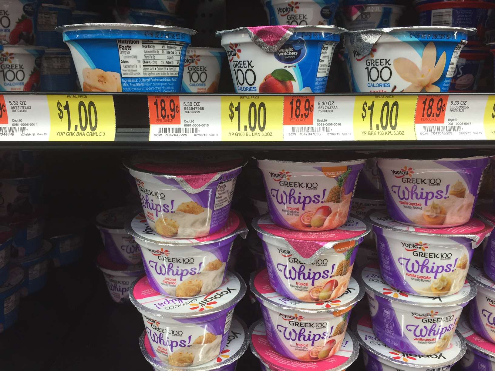 A supermarket shelf with little pots of greek yogurt 