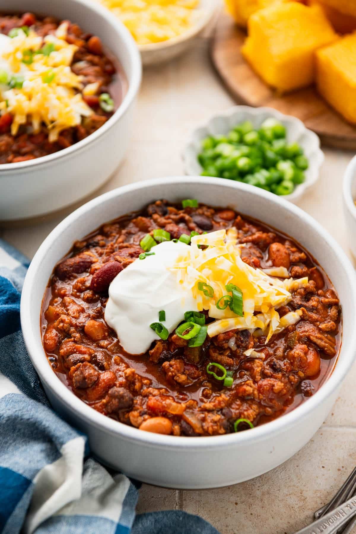 Close up front shot of two bowls of cowboy chili on a table.