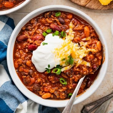 Square overhead shot of a bowl of cowboy chili.