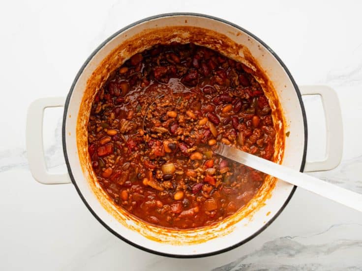 Ladle in a pot of cowboy chili.