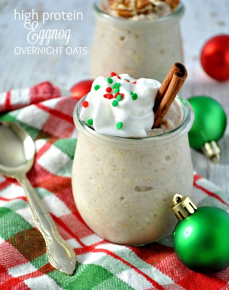 A photo of high protein eggnog overnight oats topped with cream and a cinnamon stick