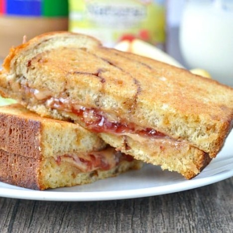 A grilled peanut butter and jelly sandwich on a plate
