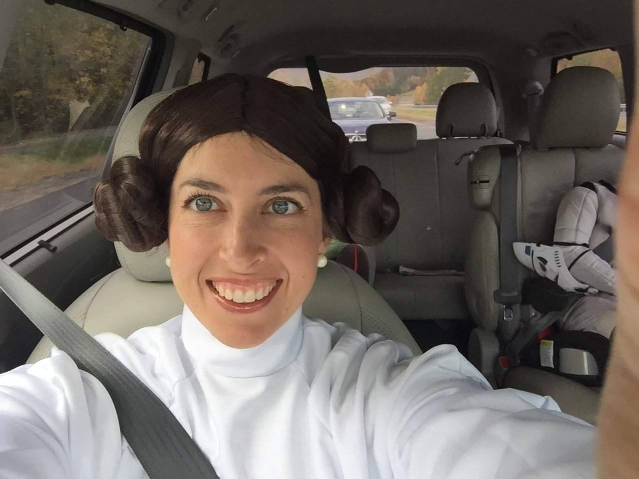 An selfie of Blair dressed up as Princess Laia from Star Wars, sitting in the front passenger seat of a car.
