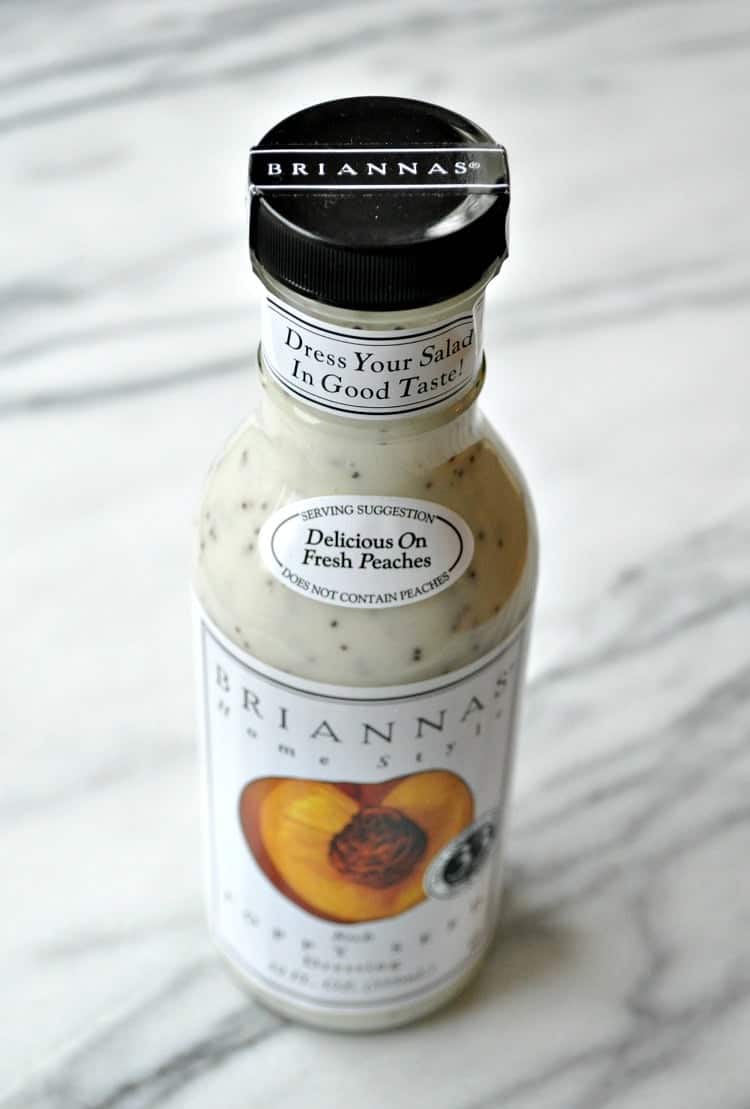 A bottle of Brianna's creamy poppyseed salad dressing sits on a marble countertop.