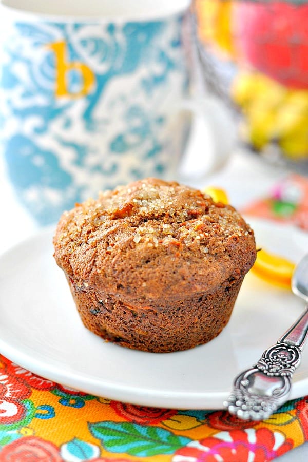Morning Glory muffin on a white plate with a blue and white mug in the background