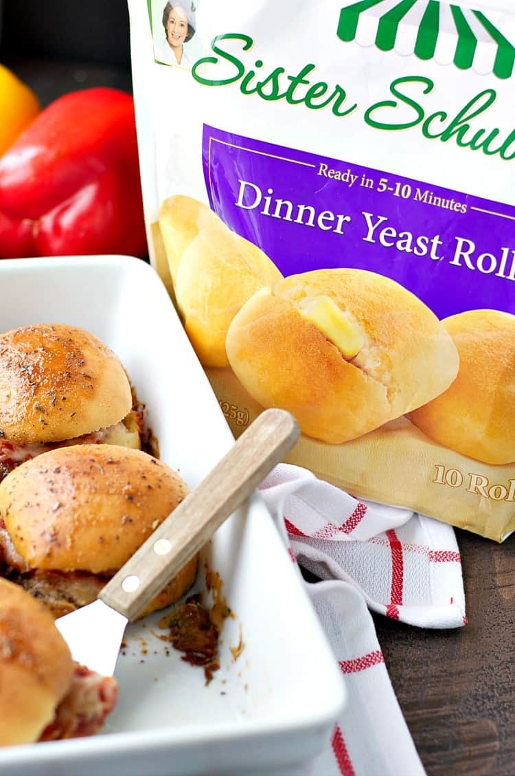 A photo of chicken parmesan sliders next to a bag of frozen dinner rolls