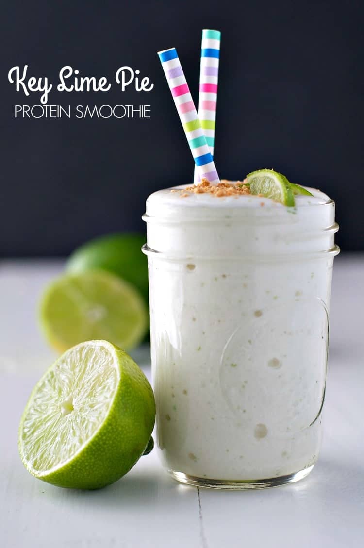 A close up of an easy key lime pie smoothie in a glass jar with limes at the side