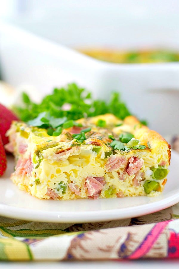 Baked omelet with spring vegetables on a white plate