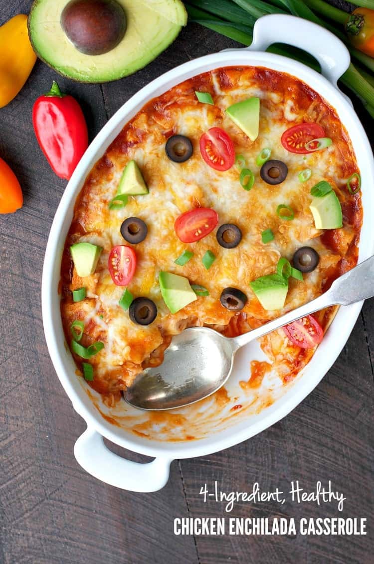 An overhead shot of a chicken enchilada casserole in a white oval dish