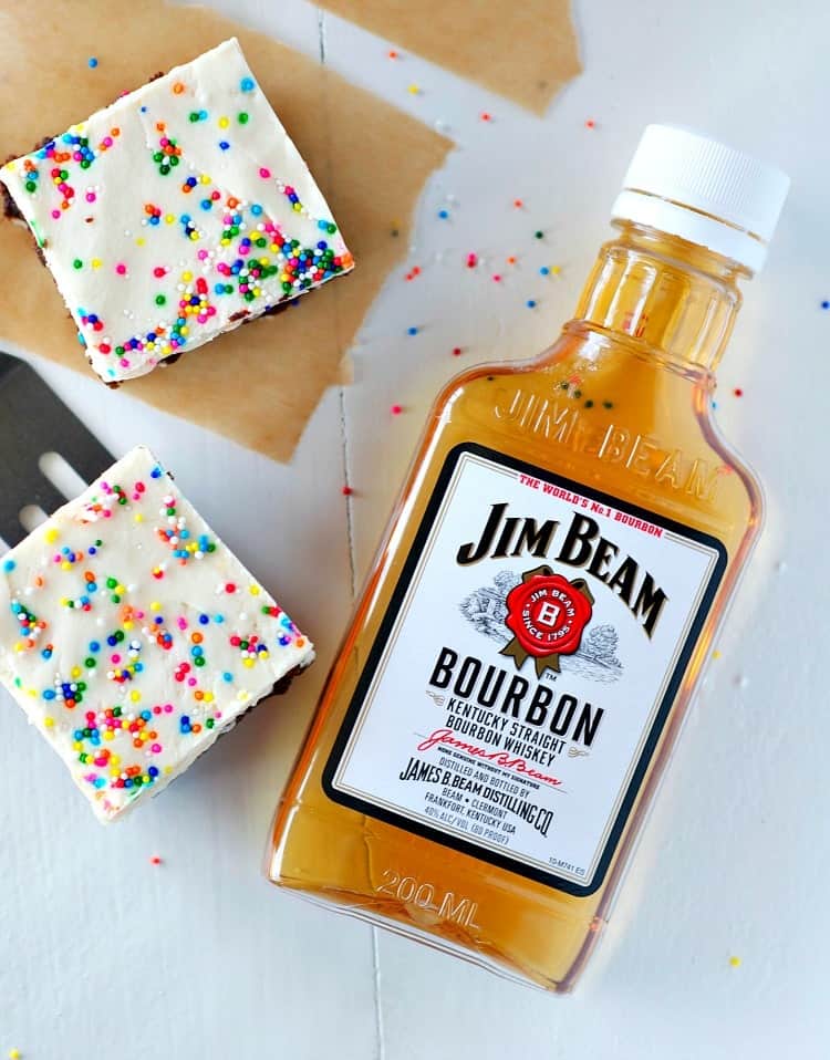 A few simple additions to a boxed brownie mix create the most decadent, festive, and EASY Derby Day Bourbon Brownies! The moist, rich brownies are spiked with Kentucky bourbon whiskey and then topped with a creamy layer of bourbon frosting for a perfectly boozy party dessert!