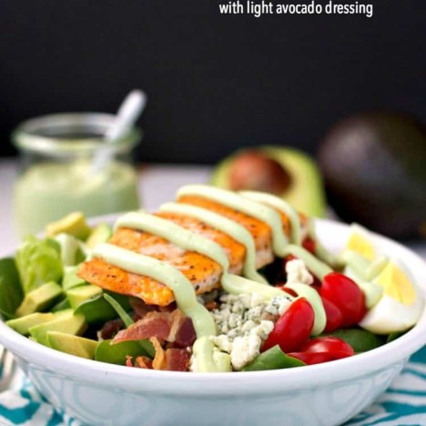A salmon cobb salad with avocado dressing in a bowl