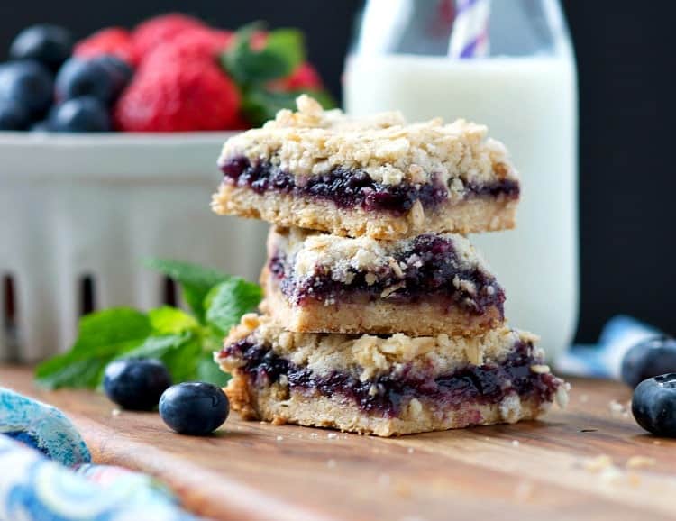 A close up of blueberry muffin bars stacked on top of each other