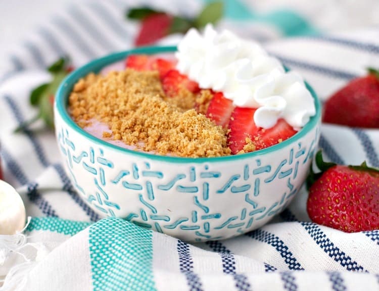 A close up of a strawberry cheesecake smoothie bowl