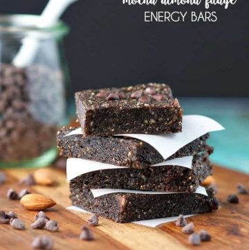 A stack of no bake homemade energy bars on a wooden board