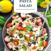 Creamy Italian pasta salad with text title overlay.