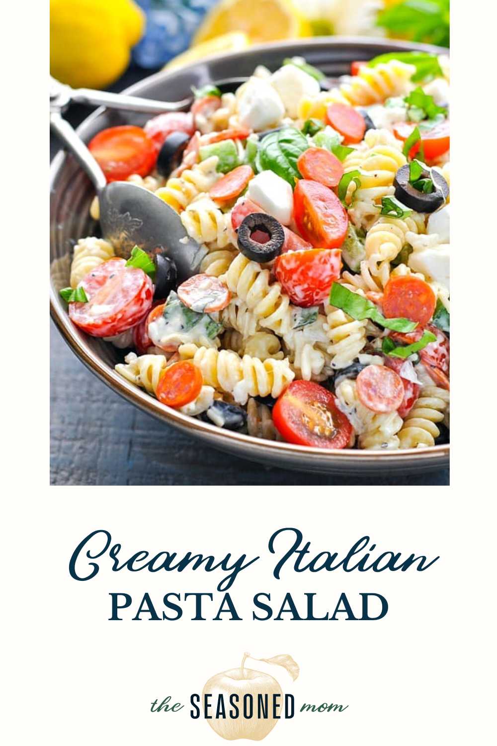 A vibrant bowl of creamy pasta salad featuring rotini and fresh garden vegetables in a rich dressing.