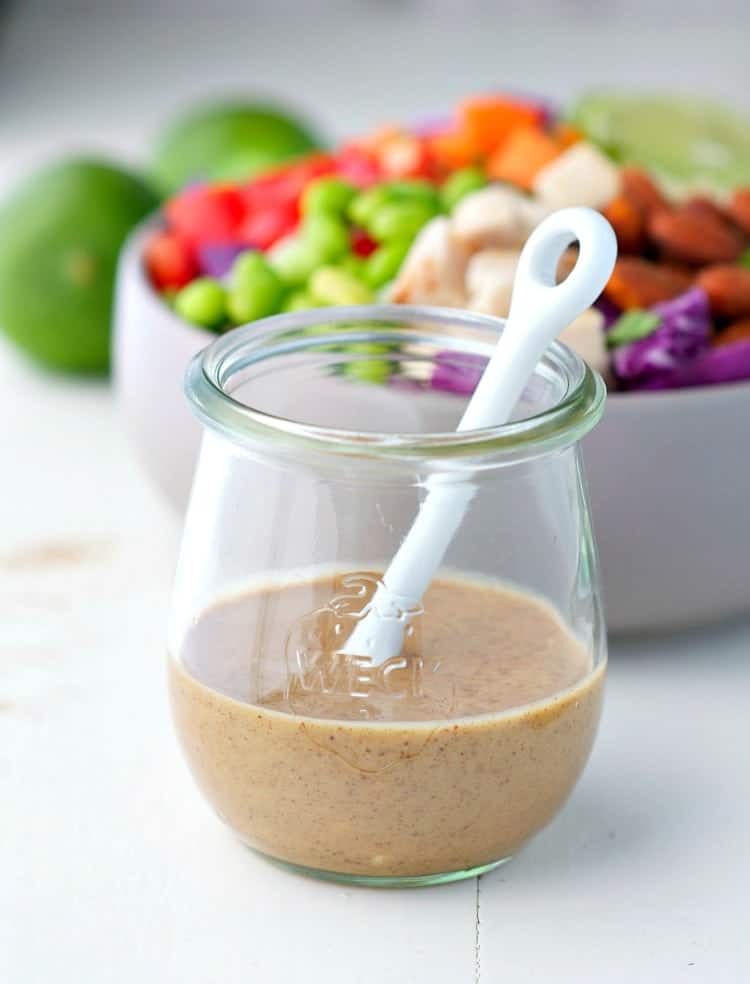 A jar of dressing for a chicken and quinoa salad