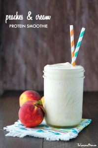 A photo of a peaches and cream smoothie in a glass jar