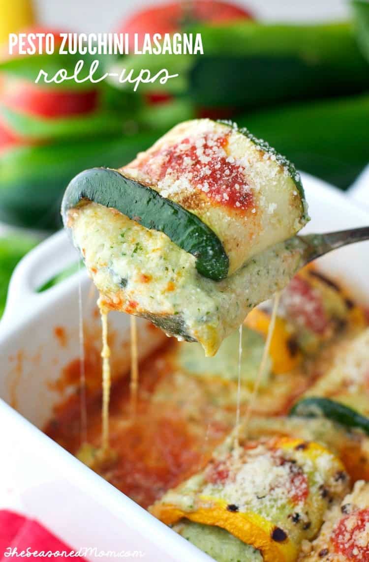 A close up of pesto zucchini lasagna roll ups on a serving spoon