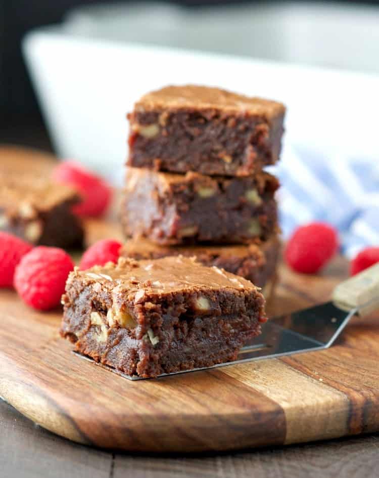 These made-from-scratch Raspberry Fudge Brownies are rich, chocolatey, and studded with crunchy walnuts. A center layer of raspberry preserves gives the dessert bars a moist, sweet, and juicy filling that is irresistible! 