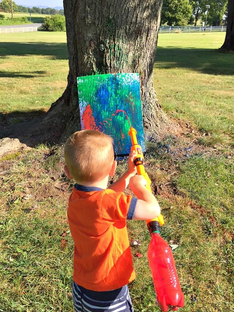 Have a BLAST with this fun outdoor activity for kids! My boys loved Painting with Water Guns while aiming at a target. It's truly the perfect summertime entertainment!