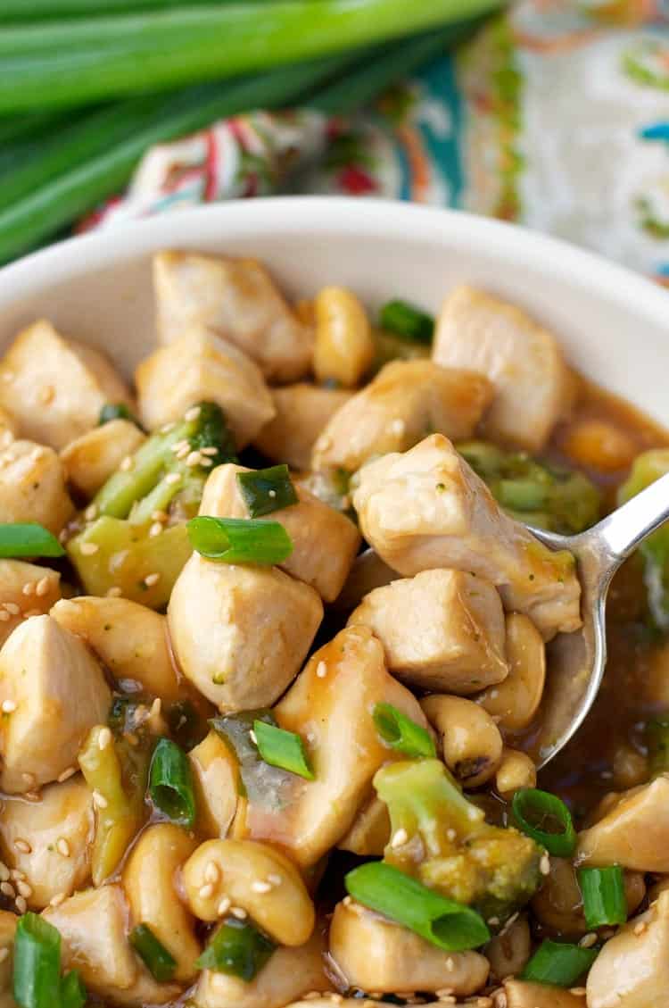 A close up of cashew chicken with green onions