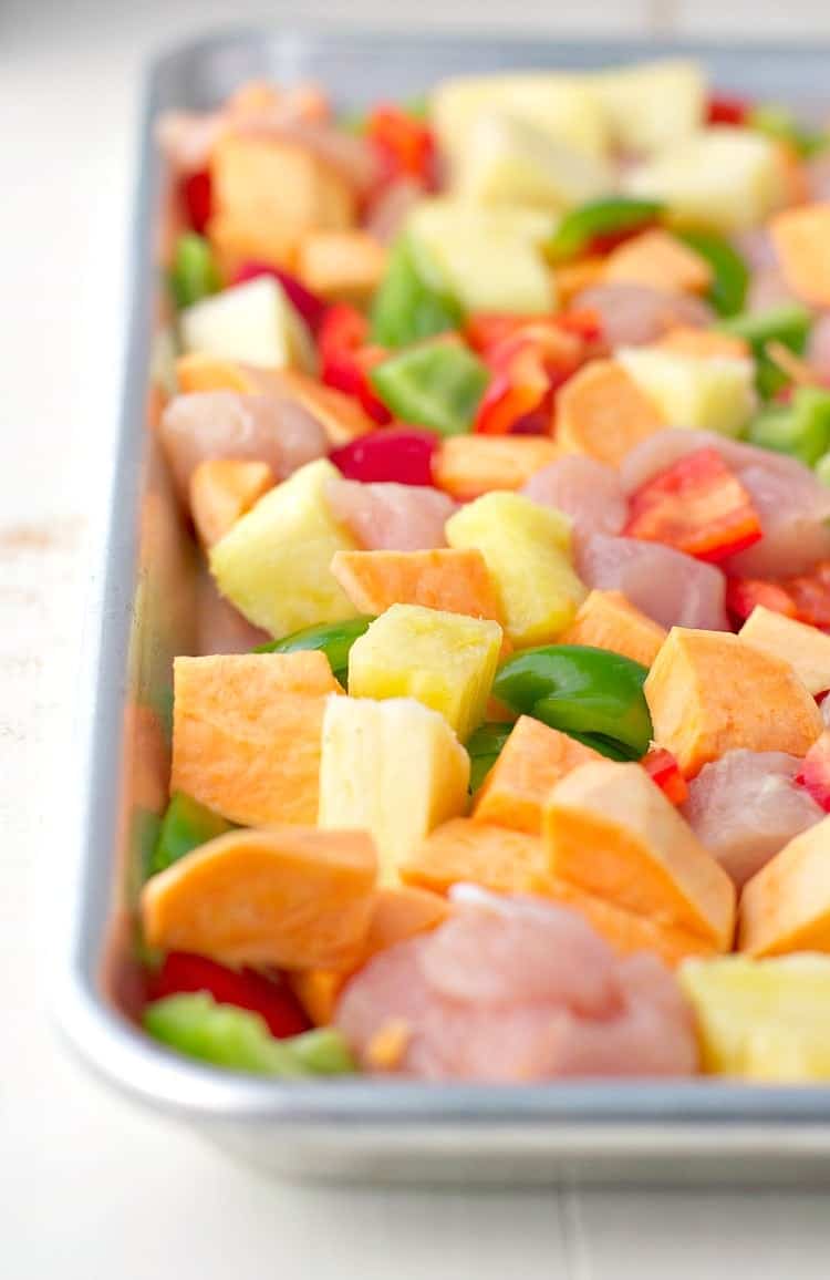 This Hawaiian Chicken with Sweet Potatoes, Peppers, and Pineapple is an easy dinner that cooks entirely on one tray! It's a healthy Sheet Pan Supper that the whole family will love -- with only a few dishes to wash at the end!