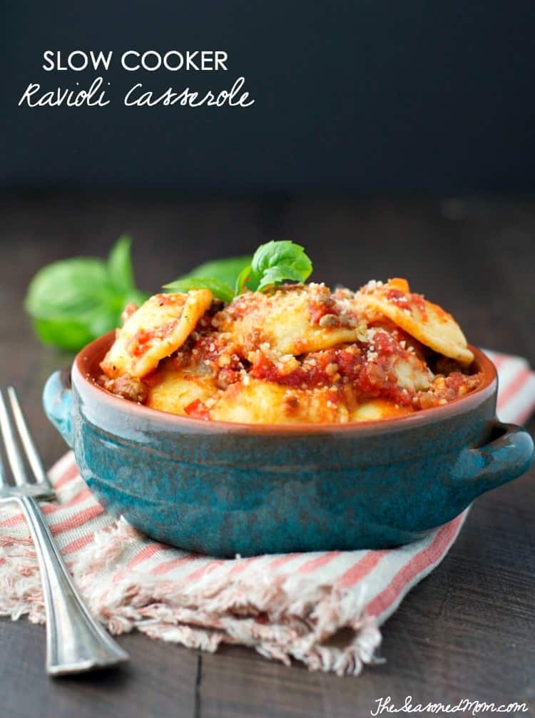 A bowl of ravioli casserole topped with fresh basil