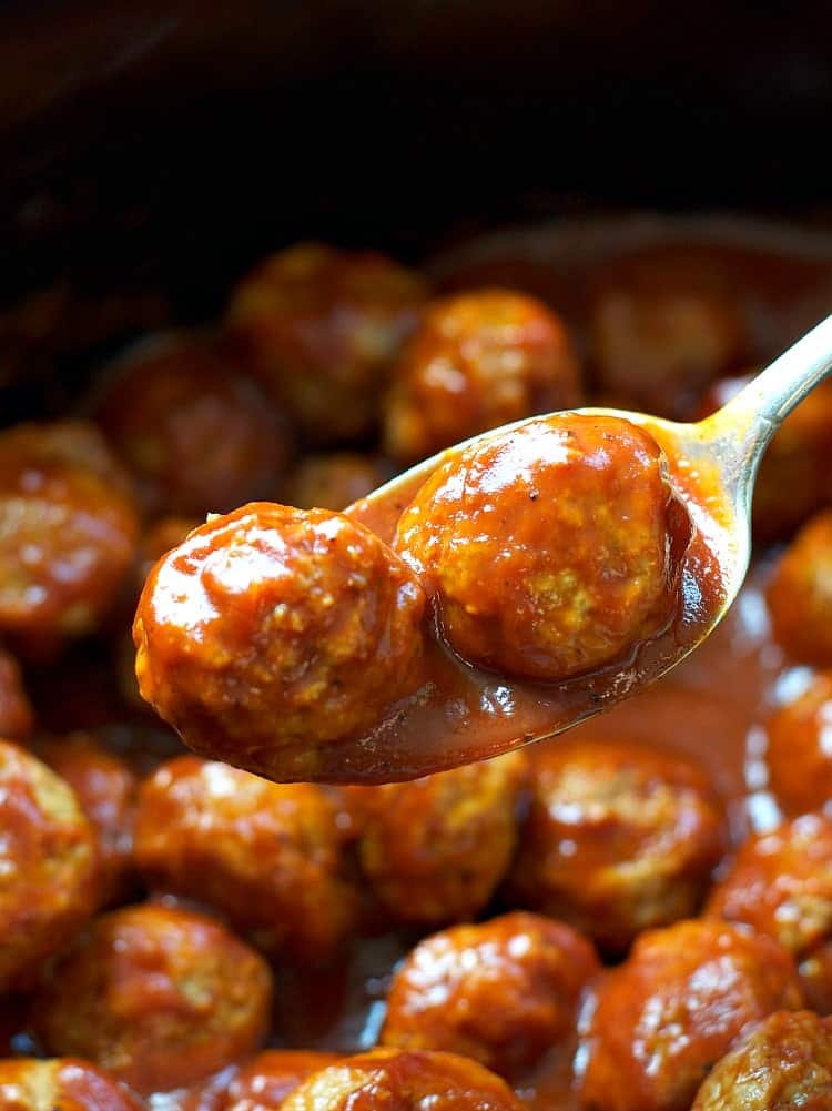 A close up of a spoonful of Slow Cooker barbecue Meatballs 