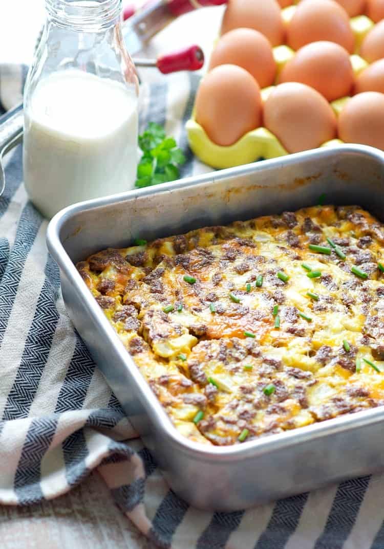 A side shot of a baked cheese omelet with sausage in a baking tray